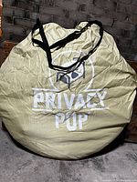 Round beige carry bag with Privacy Pop logo