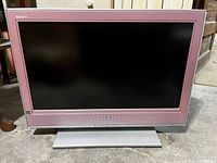 Front view of Sony Bravia TV showing screen, bezel, and stand