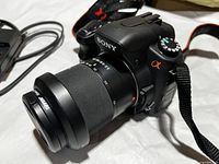 Close-up of Sony α200 body with DT 18-70mm lens and strap