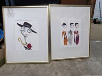 Two framed fashion illustration prints side by side