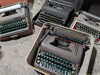Overview of four typewriters showing colours, key styles and cases