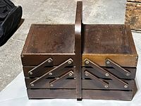 Closed wooden cantilever sewing box showing exterior, handle, and hardware
