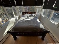 Full view of assembled queen sleigh bed frame in room