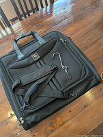 Entire garment bag with shoulder strap and hook displayed
