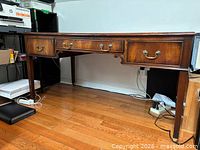 Full view of desk showing three drawers, legs and overall form