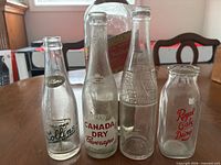Group shot of all four clear glass bottles on table