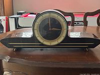 Front view of Forestville tambour mantel clock on table