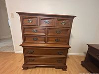 Front view showing dresser, nine drawers, brass pulls