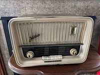 Front view showing grille, logo, knobs, frequency scale and buttons