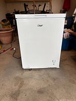 Front view of Master Chef chest freezer showing overall condition, control light, dent at lower corner