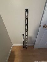 Two Mastercraft levels standing against wall, showing relative lengths