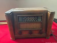 Front view of Crosley Model 12B tube radio showing wood cabinet, dial, grille, and knobs