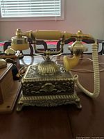Brass/ivory desk telephone left side view