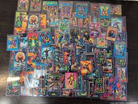 Top view of scattered Marvel Masterpieces trading cards showing quantity, artwork variety, protective sleeves