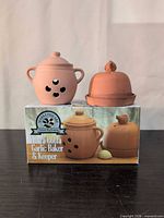 Garlic baker, garlic keeper cloche with saucer, and original box displayed