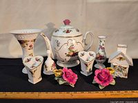 Group shot of all ten porcelain pieces showing patterns and relative sizes