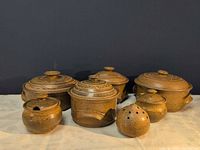 Full group of signed stoneware pieces showing sizes and lids