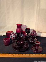 Group shot showing all eleven cranberry glass pieces