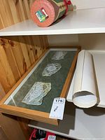 Triptych frame and rolled watercolours on shelf