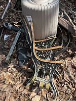 Stacked cast iron bench ends showing ornate design and wood remnants