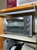 Front view of stainless convection oven showing brand label and glass door