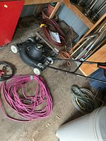 Full view of mower with three coiled extension cords