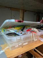 Side view of tackle box partially open showing large lures inside