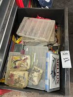 Drawer view showing multiple clear tackle boxes filled with lures and tackle