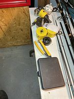 Tabletop view showing multiple yellow Starrett hole saw cups, white cup, arbors, and closed bit case