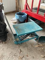 Full view of Kleton hydraulic lift cart on garage floor
