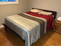 Queen bed fully made showing comforter and pillows