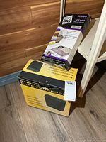 Staples shredder box beside Space Bag package