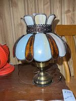 Full view of lamp showing brass-tone base and stained glass shade