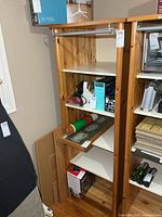 Full view of tall wooden cabinet with interior shelves