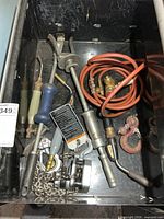 Drawer view showing hose, slide hammer, hoist, hooks, torch handles