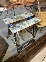 Overall view of Mastercraft foldable work stand showing frame, work surfaces, clamps, and logo