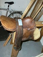 Left side view of leather saddle on stand