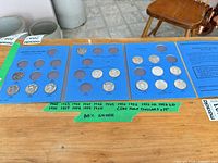 Three blue Whitman album panels with 15 Canadian half dollars inserted