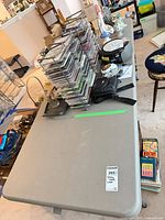 Top view of gray 6-ft folding table with items on surface