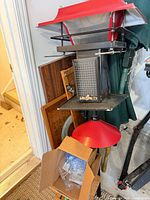 full view of red roof hopper feeder with box of accessories