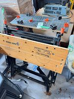 Black & Decker Workmate Plus folded, showing wooden top, metal frame and bench dogs