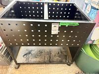 Front and side view of black steel perforated utility cart showing casters and missing top