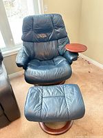 Front view of blue leather recliner with ottoman