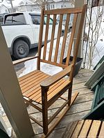 Full view of one cedar rocking chair on porch
