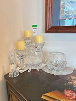 Group view of four crystal candle holders, covered candy dish, crystal bell, round bowl, underplate