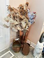 grouping of copper umbrella stand, two small buckets and florals