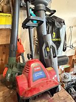 Group view showing Toro Power Shovel, Yardworks blower-vac, Black & Decker blower-vac, portion of hedge trimmer