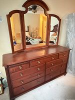 Front view of dresser with attached tri-fold mirror