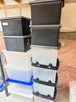 Stacks of black and clear plastic totes showing quantity and variety