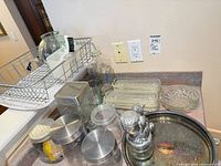 Wide view of all items on countertop: tray, nutcracker, canisters, glass dishes, jars